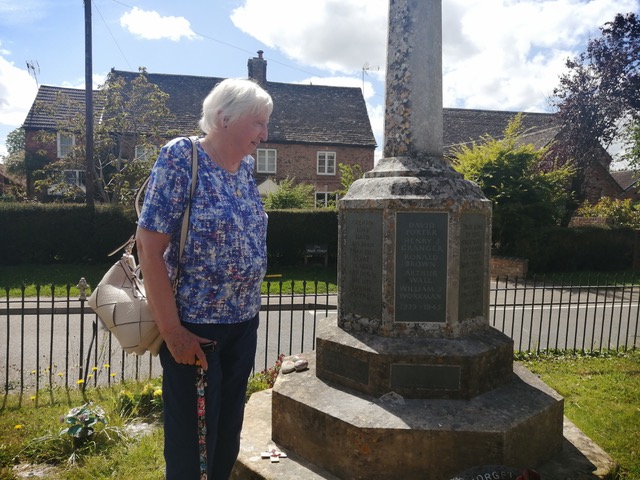 David Porter's daughter examining the replacement panel in the War Memorial.